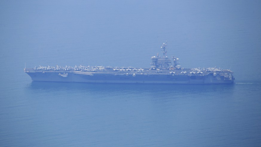 USS Carl Vinson sails in Danang Bay Monday, March 5, 2018 in Danang, Vietnam. For the first time since the Vietnam War, the U.S. Navy aircraft carrier is visiting a Vietnamese port, seeking to bolster ...