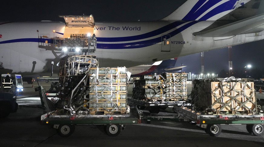 Workers unload a shipment of military aid delivered as part of the United States of America&#039;s security assistance to Ukraine, at the Boryspil airport, outside Kyiv, Ukraine, Tuesday, Jan. 25, 202 ...