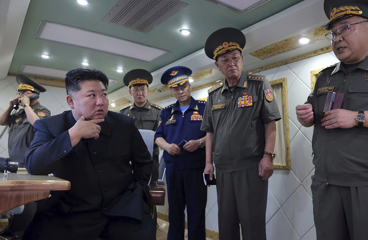 ADDS DATE - In this photo provided Sunday, Aug. 24, 2025, by the North Korean government, North Korean leader Kim Jong Un, left, supervises the test-firing of two types of new anti-air missiles at und ...