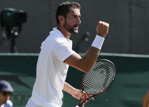 Croatia&#039;s Marin Cilic gestures after winning first set against Germany&#039;s Florian Mayer during their Men&#039;s Singles Match on day three at the Wimbledon Tennis Championships in London Wedn ...
