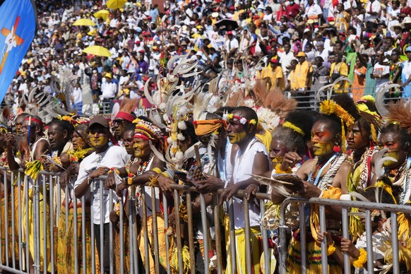 People with traditional headdress and face paint attends a holy mass by Pope Francis at Sir John Guise Stadium in Port Moresby, Papua New Guinea, Sunday, Sept. 8, 2024. (AP Photo/Mark Baker)