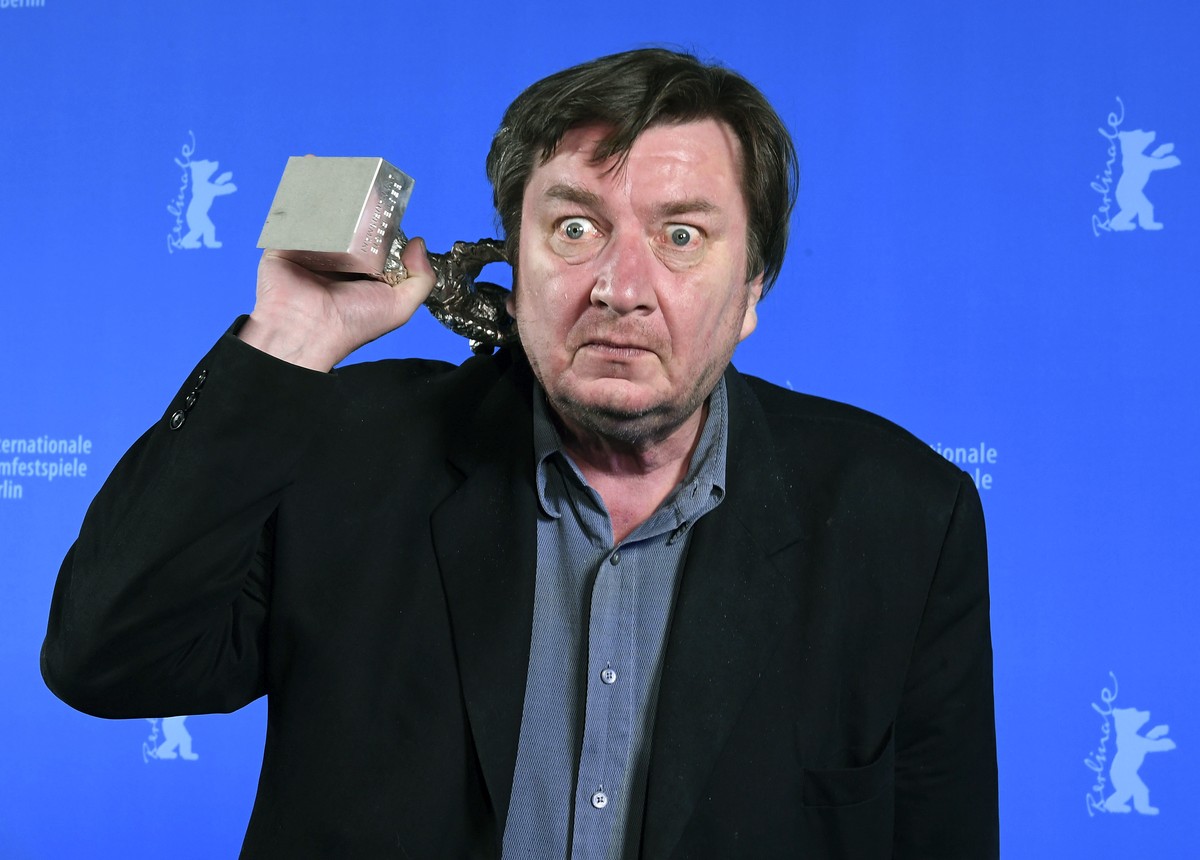Finnish director Aki Kaurismaki poses for photographers after receiving the Silver Bear for Best Director for 'The Other Side of Hope' at the awards ceremony of the 67th Berlinale Film Festi ...
