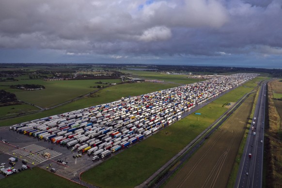 Freight lorries lined up in Manston, after French authorities announced that journeys from the UK will be allowed to resume after the coronavirus ban was lifted, but those seeking to travel must have a negative test result, in Kent, England, Wednesday Dec. 23, 2020. (Steve Parsons/PA via AP)