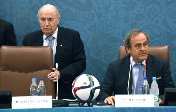 epa04859411 FIFA President Joseph Blatter (L) takes a seat next to UEFA President Michel Platini (R) as they join a seminar ahead of the Preliminary Draw for the FIFA World Cup 2018, in St.Petersburg, ...