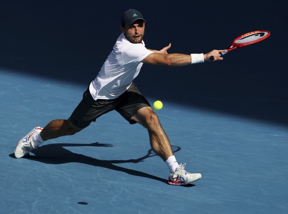 Russia&#039;s Aslan Karatsev hits a backhand return to Bulgaria&#039;s Grigor Dimitrov during their quarterfinal match at the Australian Open tennis championship in Melbourne, Australia, Tuesday, Feb. ...