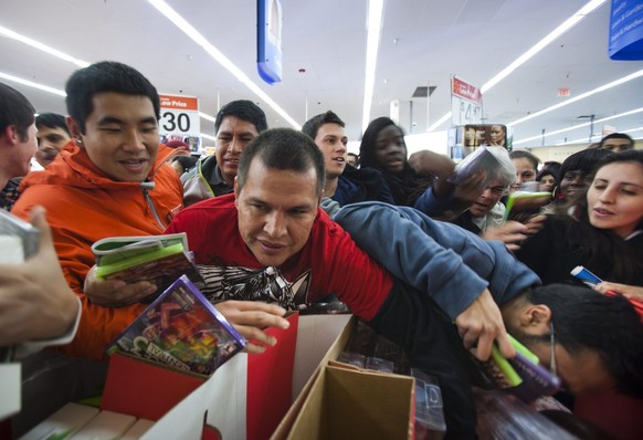 epa03482880 Bargain hunters grab video games and DVDs at the 8 p.m. opening of Wal-Mart&#039;s &#039;Black Friday&#039; sale on Thanksgiving Day in Fairfax, Virginia USA, 22 November 2012. Though Blac ...