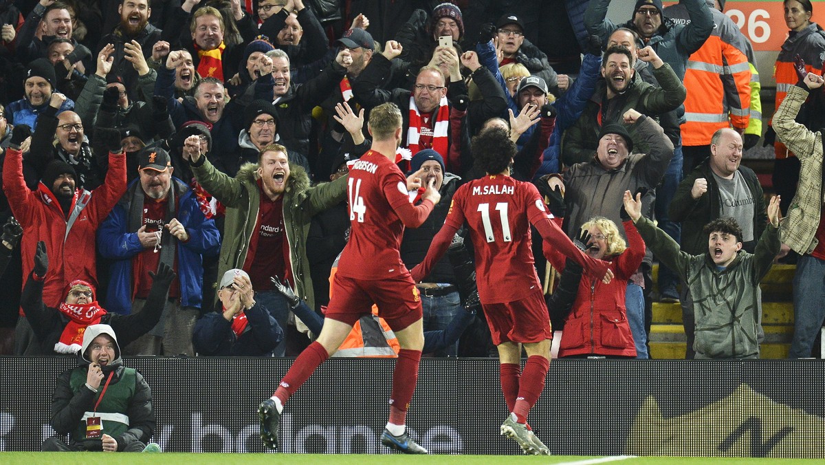 epa07986492 Mohamed Salah (R) of Liverpool celebrates with teammate Jordan Henderson (L) after scoring the 2-0 lead during the English Premier League soccer match between Liverpool FC and Manchester C ...