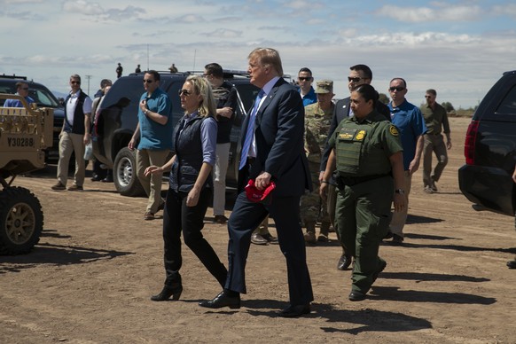 President Donald Trump walks with Homeland Security Secretary Kirstjen Nielsen as they visit a newly constructed part of a border wall with Mexico in Calexico, Calif., Friday April 5, 2019. (AP Photo/ ...