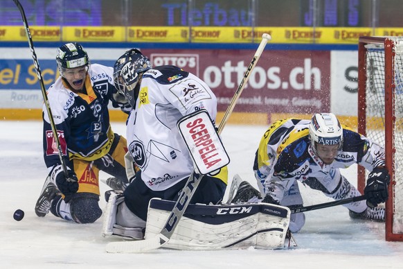 Zugs Reto Suri, links, im Spiel gegen Ambris Goalie Benjamin Conz, Mitte, und Ambris Tommaso Goi, rechts, beim Eishockeyspiel der National League zwischen dem EV Zug und dem HC Ambri-Piotta, am Freita ...