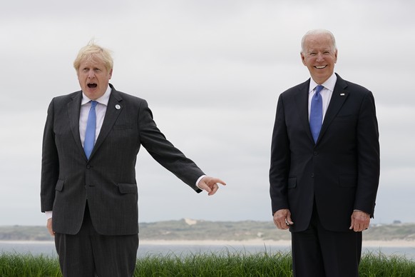 British Prime Minister Boris Johnson speaks as he and his wife Carrie Johnson pose for photos with President Joe Biden and first lady Jill Biden at the G-7 summit, Friday, June 11, 2021, in Carbis Bay, England. (AP Photo/Patrick Semansky, Pool)