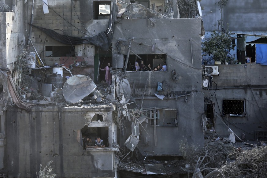 Palestinians look from windows at the damage caused by Israeli airstrikes in Jabaliya refugee camp, northern Gaza Strip, Wednesday, Nov. 1, 2023. When Secretary of State Antony Blinken was asked this  ...