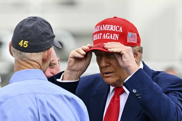 President Donald Trump talks with Sen. Rick Scott, R-Fla, after arriving on Air Force One at Daytona Beach International Airport in Daytona Beach, Fla., Sunday, Feb. 16, 2025, en route to NASCAR&#039; ...