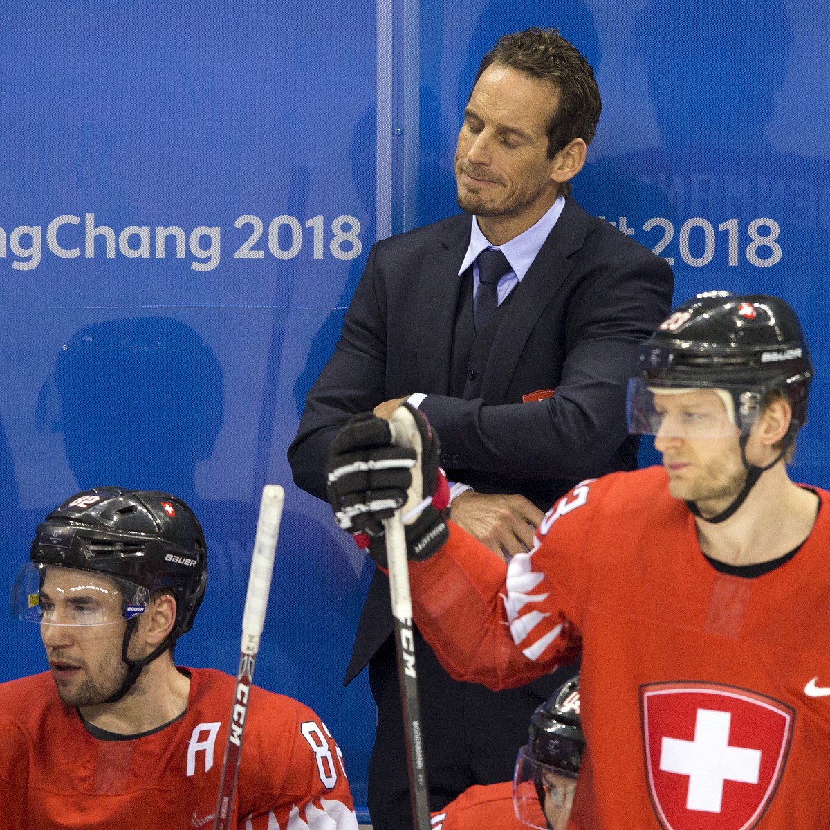 Tristan Scherwey of Switzerland, Simon Moser of Switzerland, Patrick Fischer, head coach of Switzerland, and Simon Bodenmann of Switzerland, from left, react after the men ice hockey play-off qualific ...