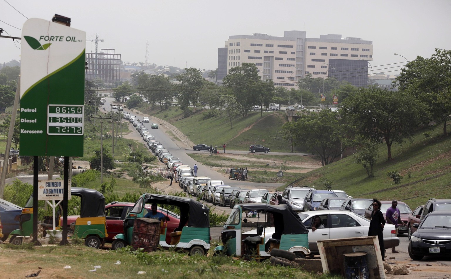 Cars queue to buy fuel at a petrol station in Abuja, Nigeria, Friday, April 1, 2016. Nigeria's oil minister apologized this week for a fuel shortage that has created long lines at gas stations an ...