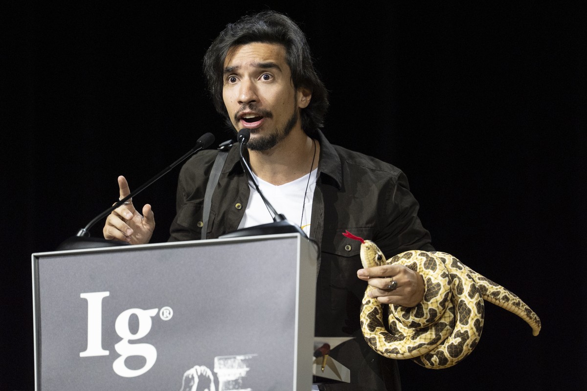 epa13210194 IG Nobel Biology Prizejoao Winner Miguel Alves Nunes speaks with a plush snake wrapped arround his arm during the 36th First Annual Ig Nobel Prize ceremony held in the Zurich Convention Ce ...