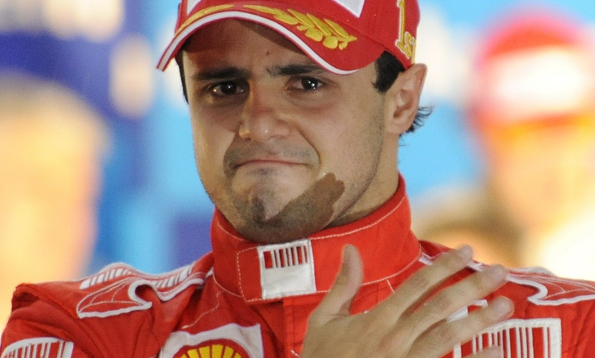 Ferrari's driver Felipe Massa of Brazil holds back tears on the podium after he won the Brazilian Grand Prix but missed to secure the 2008 Formula One world drivers championship title at Interlag ...