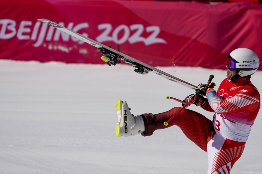 Beat Feuz of Switzerland reacts after crossing the finish line of the Alpine Skiing Men s Downhill race at the Yanqing National Alpine Skiing Center at the Beijing 2022 Winter Olympics on Monday, Febr ...