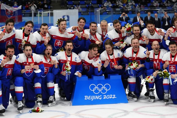 Slovakia poses for a photo after defeating Sweden in the men&#039;s bronze medal hockey game at the 2022 Winter Olympics, Saturday, Feb. 19, 2022, in Beijing. (AP Photo/Petr David Josek)