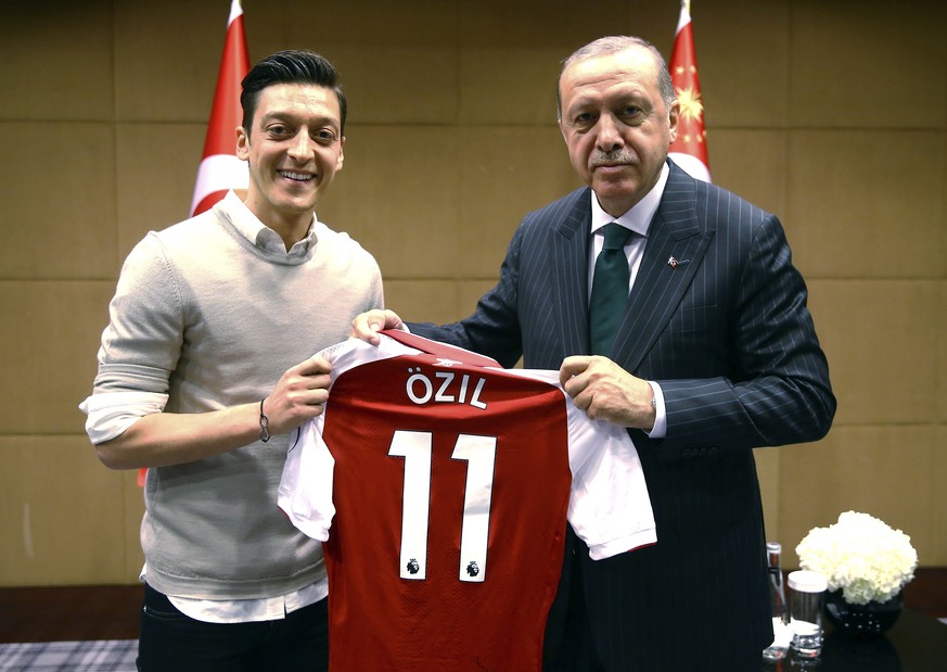 FILE - In this file photo taken on Sunday, May 13, 2018, Turkey&#039;s President Recep Tayyip Erdogan, right, poses for a photo with Arsenal soccer player Mesut Ozil in London. Germany midfielder Ozil ...