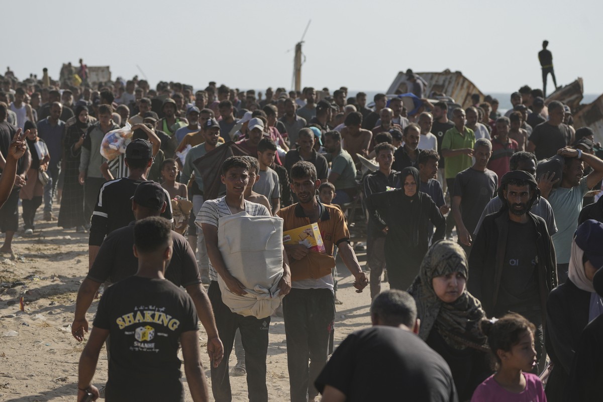 Palestinians carry boxes containing food and humanitarian aid packages delivered by the Gaza Humanitarian Foundation, a U.S.-backed organization approved by Israel, in Rafah, southern Gaza Strip, on T ...