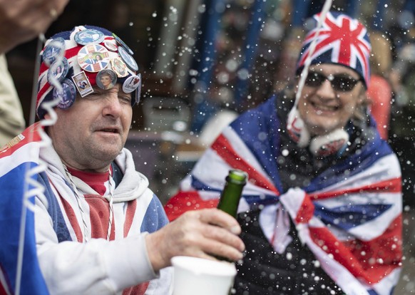 Royal fans celebrate outside Windsor Castle in Berkshire after Buckingham Palace announced the news of the birth of a baby boy born to Prince Harry and Meghan Duchess of Sussex, Monday May 6, 2019. It ...