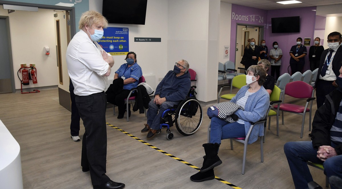 Britain's Prime Minister Boris Johnson meets people waiting for their vaccine during a visit to a coronavirus vaccination centre at the Health and Well-being Centre in Orpington, south-east Londo ...