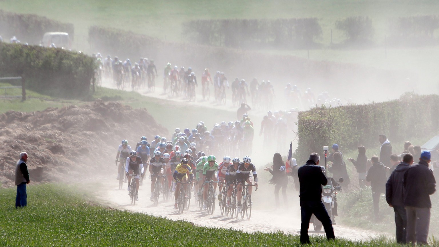 Riders steer their bikes on a cobblestone-paved section during the 112th edition of the Paris-Roubaix cycling classic, a 257 kilometer (159.69 mile) one day race, of which 51.1 kilometers (31.7 miles) ...