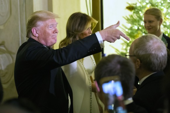 President Donald Trump with first lady Melania Trump greet guests in the Grand Foyer of the White House during the Congressional Ball, Thursday, Dec. 12, 2019, in Washington. (AP Photo/Manuel Balce Ce ...