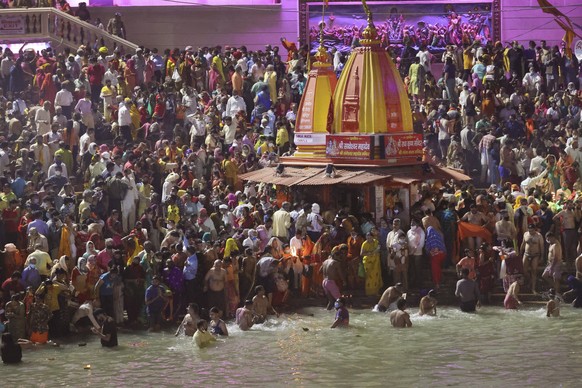 Devotees take holy dips in the Ganges River during Kumbh Mela, or pitcher festival, one of the most sacred pilgrimages in Hinduism, in Haridwar, northern state of Uttarakhand, India, Monday, April 12, ...