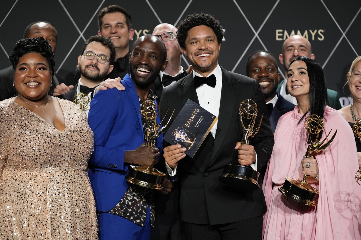 The team from "The Daily Show With Trevor Noah," winners of the award for outstanding variety talk series, pose in the press room during the 75th Primetime Emmy Awards on Monday, Jan. 15, 20 ...