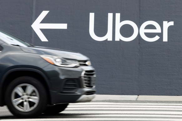 epa11487944 A vehicle passes a sign pointing toward an Uber pickup location at Washington Dulles International Airport in Dulles, Virginia, USA, 19 July 2024. Operations at various airports and airlin ...