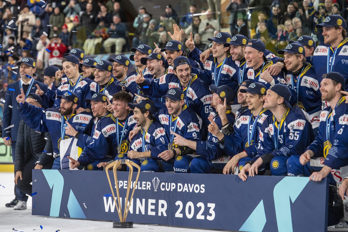 The player from Davos with Andreas Ambuehl, front, reacting after the win of Spengler Cup 2023 after the game between HC Davos from Switzerland and HC Dynamo Pardubice from Czech Republic at the Final ...