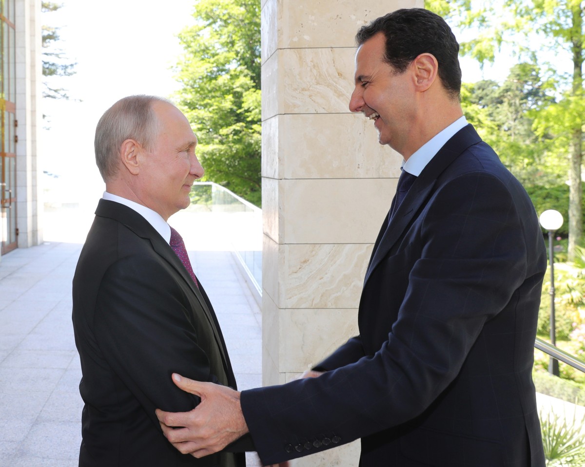 Russian President Vladimir Putin, left, reacts with Syrian President Bashar al-Assad during their meeting in the Black Sea resort of Sochi, Russia, Thursday, May 17, 2018. A transcript of Thursday ...