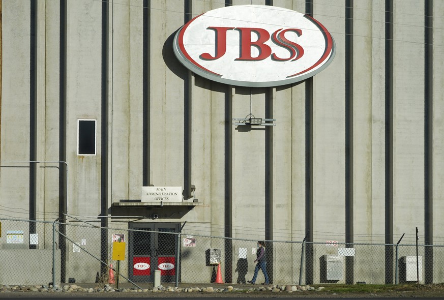 FILE - In this Oct. 12, 2020 file photo, a worker heads into the JBS meatpacking plant in Greeley, Colo. A weekend ransomware attack on the world���s largest meat company is disrupting production arou ...