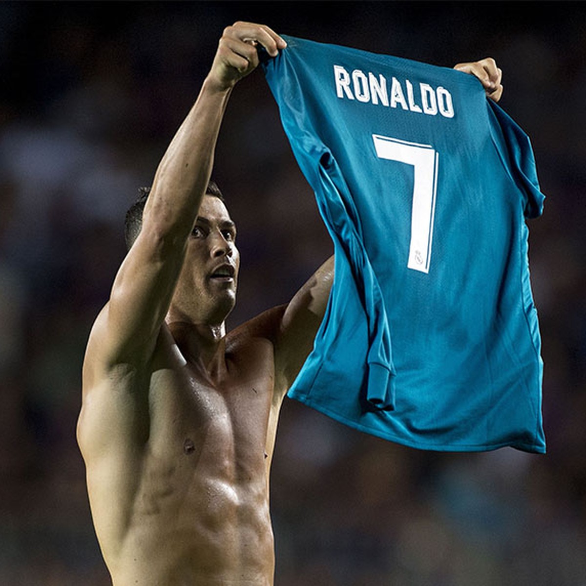 Real Madrid's Portuguese forward Cristiano Ronaldo takes off his jersey to celebrate his goal during the first leg of the Spanish Supercup football match between FC Barcelona and Real Madrid CF a ...