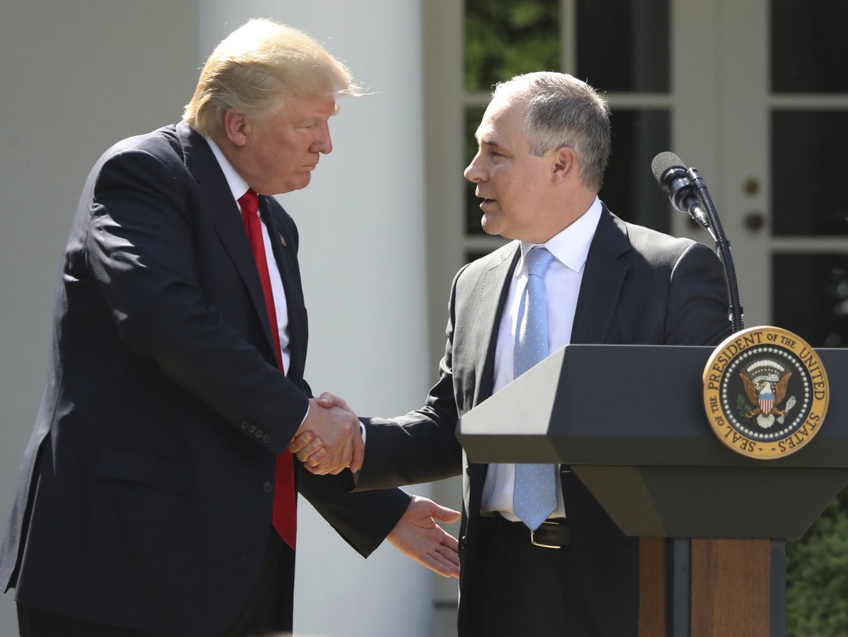 FILE - In this June 1, 2017 file photo, President Donald Trump shakes hands with EPA Administrator Scott Pruitt after speaking about the U.S. role in the Paris climate change accord in the Rose Garden ...