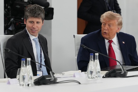 U.S. President Donald Trump talks to CEO of OpenAI Sam Altman as they participate in a meeting with leaders during the G7 summit, Wednesday, June 17, 2026, in Evian-les-Bains, France. (AP Photo/Julia  ...