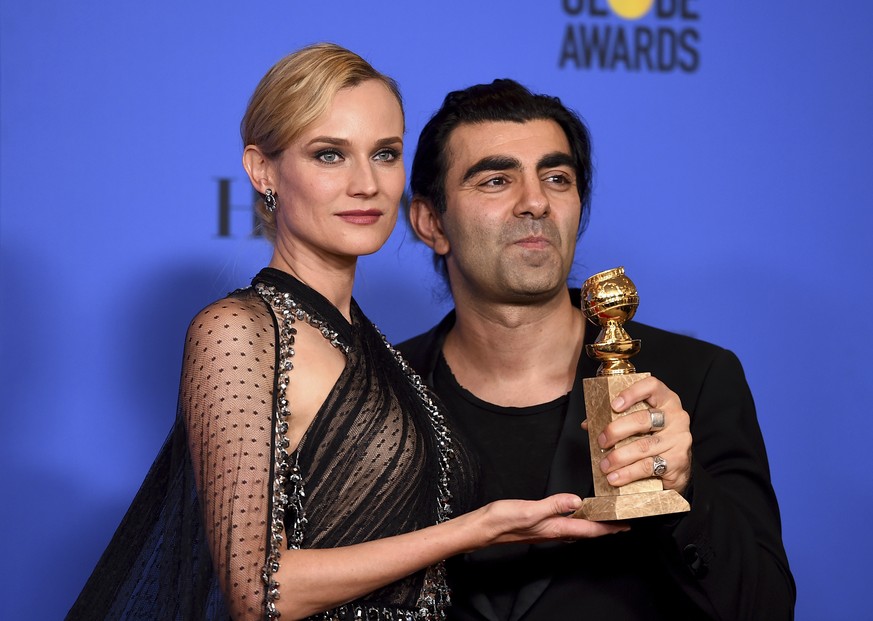 Diane Kruger, left, and Fatih Akin poses in the press room with the award for best motion picture - foreign language for &quot;In The Fade&quot; at the 75th annual Golden Globe Awards at the Beverly H ...