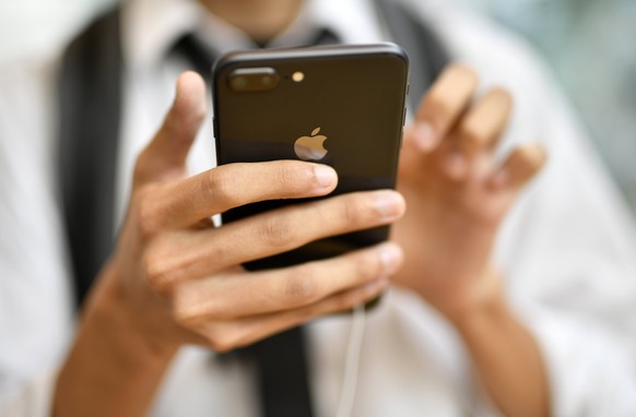 epa06218650 A young man looks at Apple&#039;s new iPhone 8 Plus at the Apple Store of Omotesando shopping district in Tokyo, Japan, 22 September 2017. Apple launched the iPhone 8 and the Apple Watch S ...