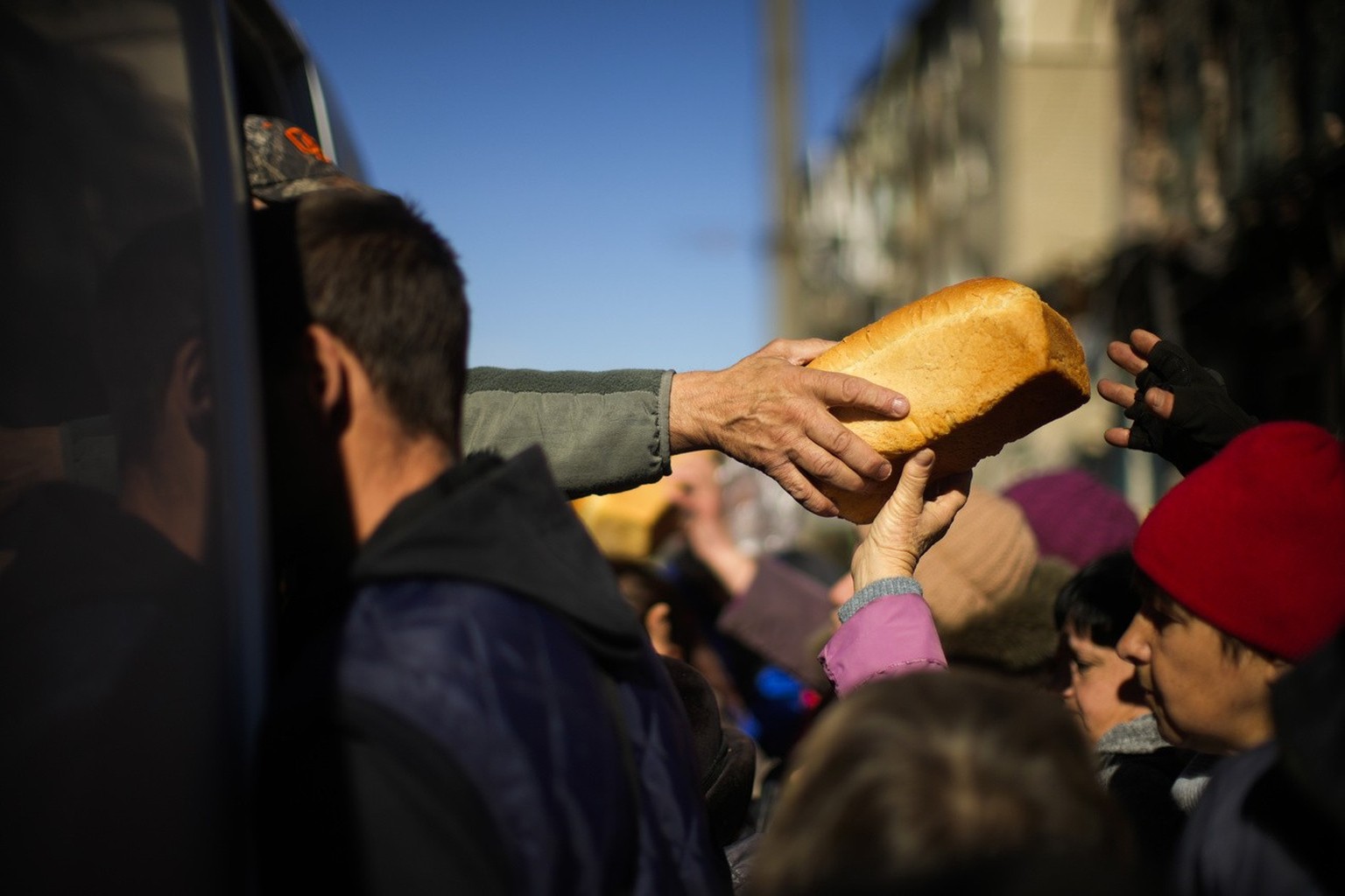 Locals receive food and everyday necessities given by Ukrainian volunteers in Izium, Ukraine, Wednesday, Oct. 12, 2022. Residents in Izium have been living with no gas, electricity or running water su ...
