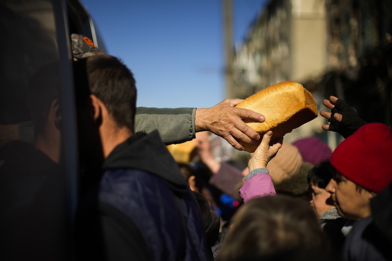 Locals receive food and everyday necessities given by Ukrainian volunteers in Izium, Ukraine, Wednesday, Oct. 12, 2022. Residents in Izium have been living with no gas, electricity or running water su ...