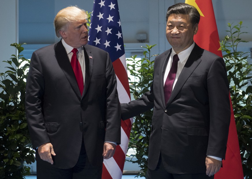 US President Donald Trump and Chinese President Xi Jinping, right, arrive for a meeting on the sidelines of the G-20 Summit in Hamburg, Germany, Saturday, July 8, 2017. (Saul Loeb/Pool Photo via AP)