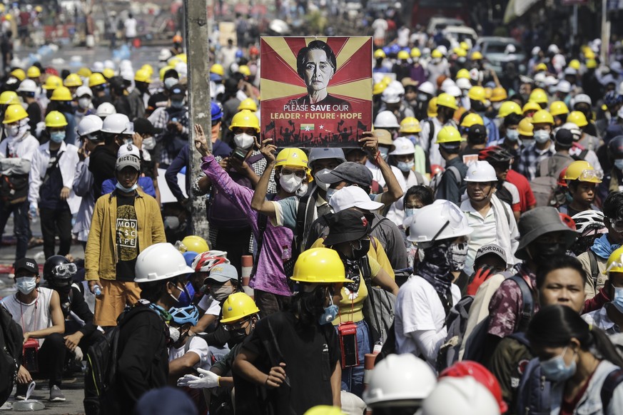 epa09045642 A demonstrator holds a placard calling for the release of detained Myanmar State Counselor Aung San Suu Kyi during a protest against the military coup in Yangon, Myanmar, 02 March 2021. Fo ...