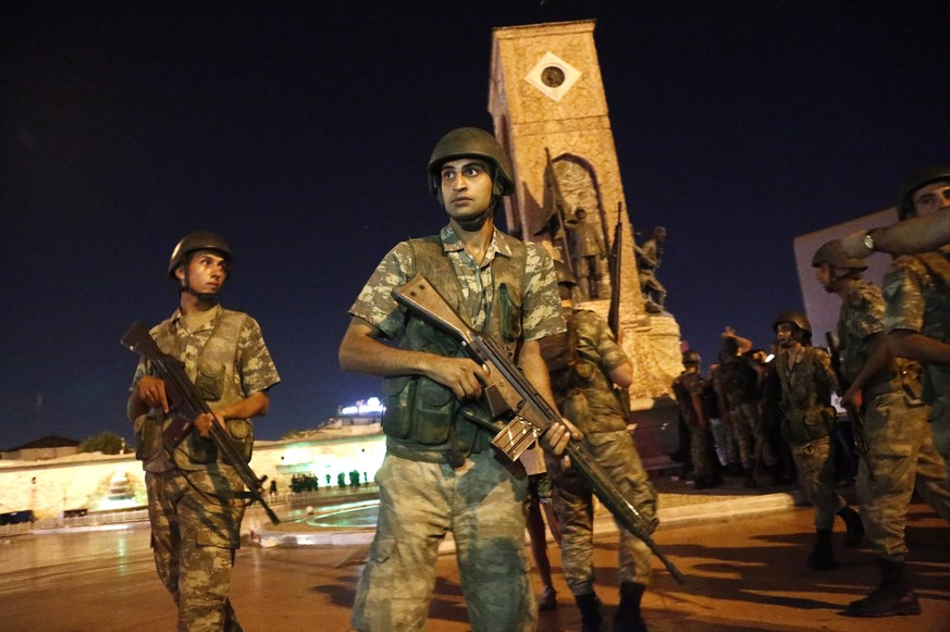 epa05427110 Turkish soldiers stand guard at the Taksim Square in Istanbul, Turkey, 16 July 2016. Turkish Prime Minister Yildirim reportedly said that the Turkish military was involved in an attempted  ...