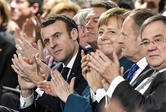 French President Emmanuel Macron, front left, German chancellor Angela Merkel, 3rd right, and President of the European Council Donald Tusk, 2nd right, applaude after the signing of a new Germany-Fran ...