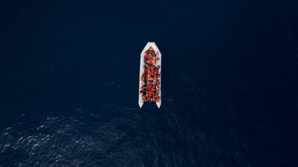 Refugees and migrants wait to be rescued by members of the Spanish NGO Proactiva Open Arms, after leaving Libya trying to reach European soil aboard an overcrowded rubber boat, north of Libyan coast,  ...