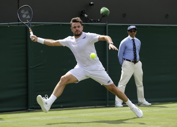 Switzerland&#039;s Stan Wawrinka returns in his Men&#039;s singles match against United States&#039; Reilly Opelka during day three of the Wimbledon Tennis Championships in London, Wednesday, July 3,  ...