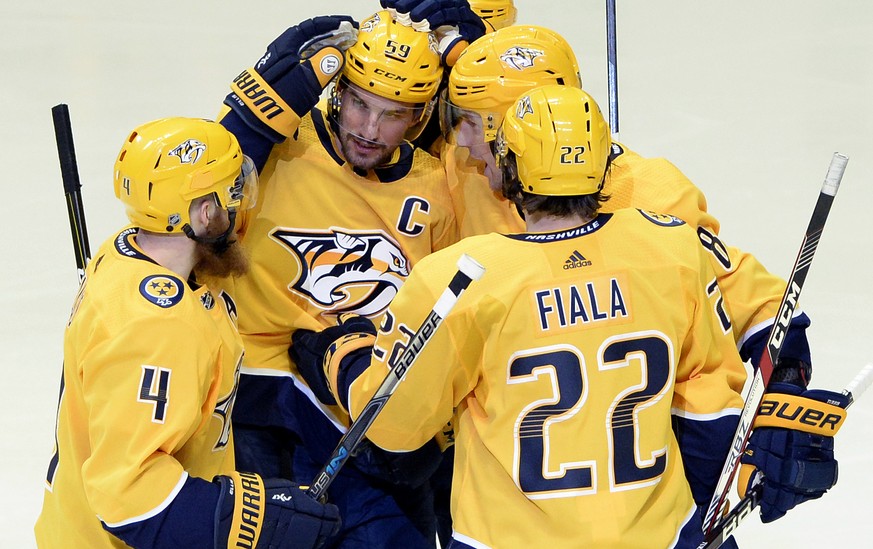 Nashville Predators defenseman Roman Josi (59), of Switzerland, celebrates with teammates after scoring a goal against the Minnesota Wild during the first period of an NHL hockey game Tuesday, March 2 ...