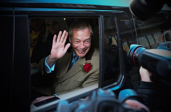 RAMSGATE, ENGLAND - MAY 07: Ukip leader Nigel Farage waves from his car as he leaves after casting his vote for the South Thanet constituency on May 7, 2015 in Ramsgate, England. The United Kingdom ha ...