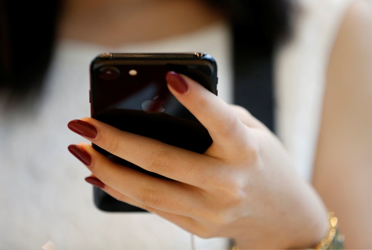 Momoko Toyotake tries to use Apple's new iPhone 7 in the new jet black colour on display, after the new iPhone 7 went on sale at the Apple Store at Tokyo's Omotesando shopping district, Japa ...